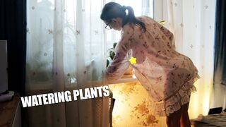 Transparent watering houseplants with beautiful model in a dress